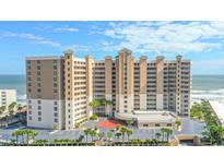 Stunning high-rise beachfront condo building with ocean views, palm trees, and well-maintained landscaping at 2403 S Atlantic Ave # 209, Daytona Beach Shores, FL 32118