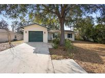 Charming single story home with attached one-car garage, mature trees, and a well-maintained lawn at 370 Charles Ave, Orange City, FL 32763