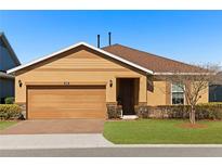 Charming one-story home featuring a well-manicured lawn, brick-paved driveway, and an attached two-car garage at 5065 Nw 35Th Pl, Ocala, FL 34482