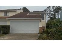 Attached garage with a white door on a two-story home at 1101 Monticello Ln # 3, Port Orange, FL 32129