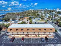 An aerial view of a multi-Gathering residence with ample parking and a cityscape view in the background at 144 S Halifax Ave # 86, Daytona Beach, FL 32118