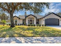 Charming single-story home with a well-manicured lawn, a covered entrance and a two car garage at 509 Kettering Rd, Deltona, FL 32725