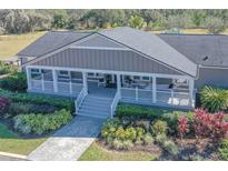 Charming single-story home with a spacious front porch and beautifully landscaped front yard at 5306 Empire Church Rd, Groveland, FL 34736