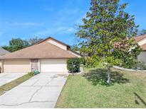 Charming home featuring a two-car garage, well-maintained lawn, and lovely curb appeal at 6157 Sequoia Dr, Port Orange, FL 32127