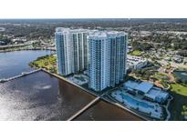 Aerial view of two modern high-rise condo towers on the water with lush landscaping and community pool at 241 Riverside Dr # 1502, Daytona Beach, FL 32117