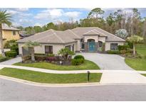 Stunning home featuring a well manicured lawn, charming landscaping, a paver driveway, and a striking tile roof at 564 Bent Pine Ct, Sanford, FL 32771