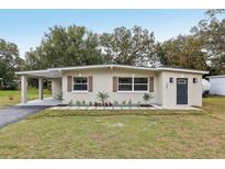 Charming single-story home with light stucco, dark shutters, and a well-manicured front yard at 722 Valencia Ave, Orange City, FL 32763