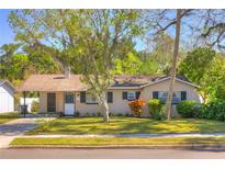 Charming single-story home featuring a well-manicured lawn, mature trees, and cozy curb appeal at 741 Greenway Pl, Daytona Beach, FL 32114