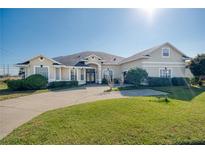Charming single-story home with a well-manicured lawn, a circular driveway, and beautiful architectural details at 1051 Dunbar Ave, Sanford, FL 32771