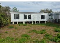 Charming single-story home featuring white siding, black shutters, and a well-maintained front yard at 1367 Vine St, Daytona Beach, FL 32117