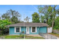 Charming single-story home with blue exterior, white trim, and a well-maintained front yard at 1702 Carolina Ave, Ormond Beach, FL 32174