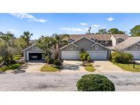 Inviting townhome with a two-car garage and well-maintained landscaping in a quiet neighborhood at 2015 Cornell Pl, Port Orange, FL 32128