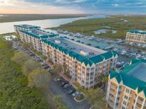 Stunning aerial view of waterfront condos with marina and lush surroundings at 4626 Harbour Village Blvd # 3302, Ponce Inlet, FL 32127
