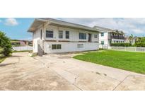 Two-story home featuring a spacious driveway and a lush green yard at 4734 S Atlantic Ave, Ponce Inlet, FL 32127