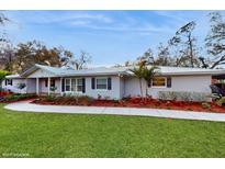 Charming one-story home with well-manicured lawn, walkway, and lush landscaping at 7108 East Rd, Lakeland, FL 33809
