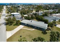 Aerial view of a charming home showcasing its well-manicured lawn, established landscaping, and inviting curb appeal at 72 Rockefeller Dr, Ormond Beach, FL 32176
