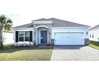 Charming single-story home with stone accents, brick paved drive, and well-maintained landscaping at 1077 Chelan Falls N Trl, Deland, FL 32724