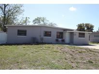 Charming single-story home with a well-maintained lawn and an inviting entrance at 1103 Malcom Rd, Ocoee, FL 34761