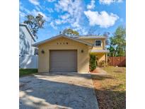 Inviting home featuring a gray garage door, complemented by a well-maintained lawn at 1118 Meditation Loop, Port Orange, FL 32129
