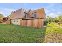 Charming home with a balcony, fenced yard, and lush green lawn at 116 Moonstone Ct, Port Orange, FL 32129
