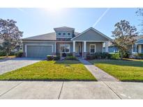 Charming one-story home featuring a well-manicured lawn, covered porch, and neutral paint scheme at 1204 Draycott St, Ormond Beach, FL 32174