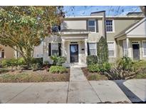 Charming two-story townhome with landscaped yard and inviting entryway at 214 Woodhouse Ln, Deland, FL 32724