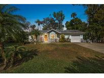 Charming single-story home with well-manicured lawn and tropical landscaping at 2249 Swoope Dr, New Smyrna Beach, FL 32168