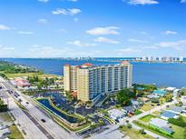 Stunning aerial view of a waterfront condo building offering beautiful views of the water and city skyline at 2801 S Ridgewood Ave # 1214, South Daytona, FL 32119