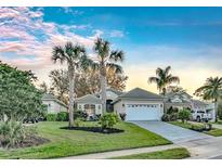 Beautiful single-story home featuring mature landscaping, palm trees, and a well-maintained lawn at 411 Foxhill Dr, Debary, FL 32713