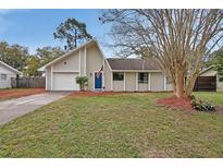 Charming single-story home with a manicured lawn and inviting blue front door at 605 Anderson Dr, Deltona, FL 32725