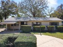 Charming single-story home with a carport, manicured landscaping, and a welcoming walkway at 61 West Highbanks, Debary, FL 32713