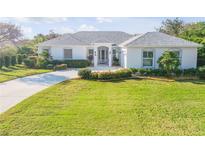 Beautiful one-story home with a well-manicured lawn and lovely landscaping, perfect for curb appeal at 65 Calumet Ave, Ponce Inlet, FL 32127