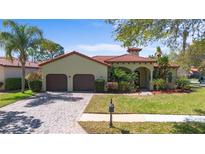 Charming home with a well-maintained lawn, brick driveway, and a beautiful terracotta roof at 100 Via Rosa Ct, Debary, FL 32713