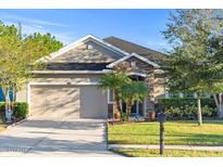 Charming single-story home with a stone-accented entryway and a well-maintained front yard at 118 Grande Belfly Way, Daytona Beach, FL 32124