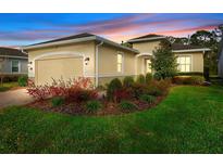 Inviting single-story home with attached garage and colorful, manicured landscaping at 1341 Hayton Ave, Deland, FL 32724