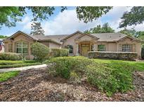 Beautiful home with a meticulously landscaped front yard and a stone-accented facade at 1491 W Silver Hammock, Deland, FL 32720