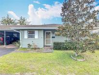 Charming single-story home featuring a well-maintained lawn and mature landscaping at 202 Oakleigh Dr # 90, Deland, FL 32724