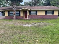 Charming single-story home featuring a well-maintained lawn and an inviting facade at 4605 Hard Rock Cv, Sanford, FL 32773