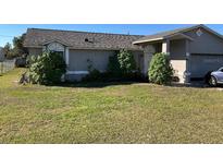 Charming single-story home with lush front lawn and mature landscaping at 662 Comstock Dr, Deltona, FL 32738