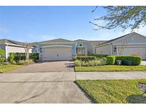 Charming single-story home featuring a brick driveway and well-manicured landscaping at 1079 Lincolnshire Dr, Deland, FL 32724