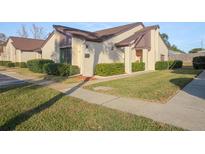 Charming condo with well-maintained landscaping, manicured shrubs, and a cozy, inviting front entrance at 101 Grand Plaza Dr # M1, Orange City, FL 32763