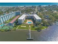 Expansive aerial view of the condo complex, highlighting its pool, tennis courts, waterfront access, and ocean views at 1224 S Peninsula Dr # 210, Daytona Beach, FL 32118