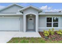 Inviting entryway showcasing the front door and well-manicured landscaping at 1329 N Old Mill Dr, Deltona, FL 32725