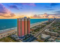 Beautiful aerial view of the oceanfront condo tower with sunrise on the beach at 1900 N Atlantic Ave # 504, Daytona Beach, FL 32118