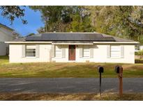 Charming single-story home featuring solar panels and a well-maintained front yard at 2044 7Th Ave, Deland, FL 32724