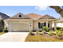 Charming single-story home with a well-manicured lawn and attached two-car garage, great curb appeal at 307 Heron Point Way, Deland, FL 32724