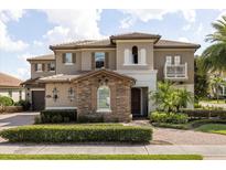 Beautiful two-story home featuring manicured landscaping, a tile roof, and a welcoming entrance at 3955 Equine Cv, Lake Mary, FL 32746