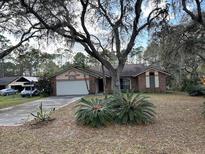 Charming single-story home with a two-car garage and mature landscaping in a quiet neighborhood at 4164 New Marsh Rd, Deland, FL 32724