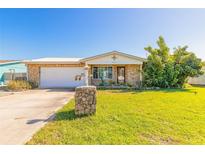 Charming home with stone accents, well-maintained lawn and a metal roof at 44 Sunset Blvd, Ormond Beach, FL 32176