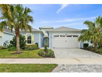 Charming single-Gathering home with a two-car garage, palm trees, and well-maintained landscaping at 464 Tropics Ave, Daytona Beach, FL 32124